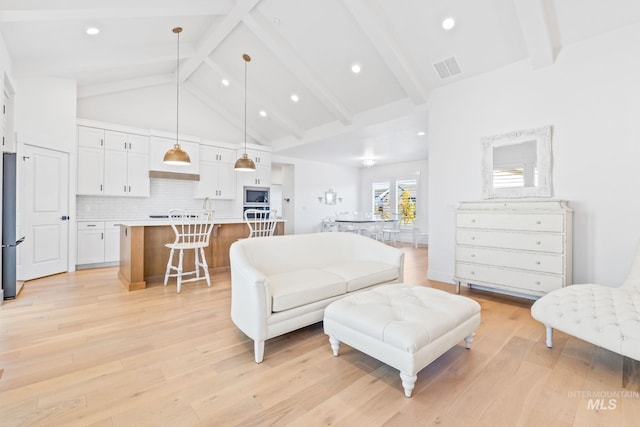 8456 W Meltwater Ln, Eagle, ID 83616 - living area featuring beamed ceiling, light wood-type flooring, high vaulted ceiling, and recessed lighting