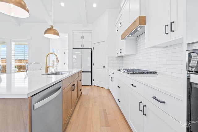 8456 W Meltwater Ln, Eagle, ID 83616 - kitchen featuring appliances with stainless steel finishes, a sink, beam ceiling, light wood finished floors, and backsplash