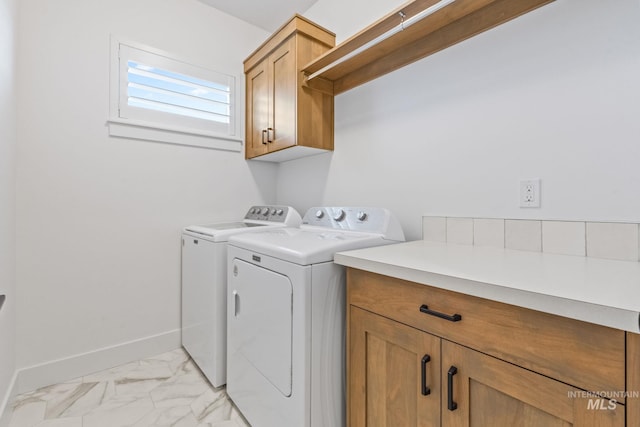 8456 W Meltwater Ln, Eagle, ID 83616 - laundry room with cabinet space, separate washer and dryer, light marble finish floors, and baseboards