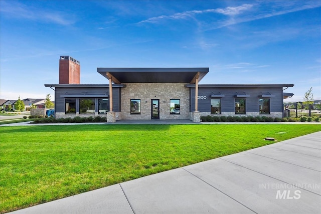 8456 W Meltwater Ln, Eagle, ID 83616 - rear view of house with stone siding, a chimney, and a yard