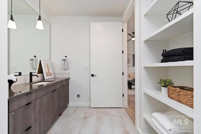 bathroom featuring vanity, baseboards, ceiling fan, and tile patterned floors
