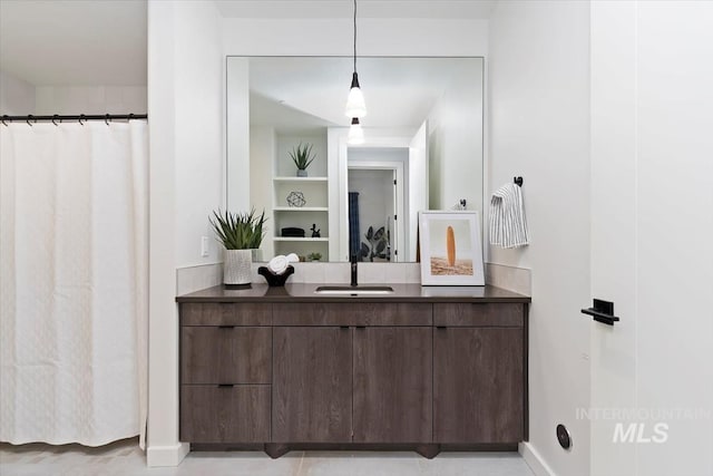 bathroom with vanity and baseboards