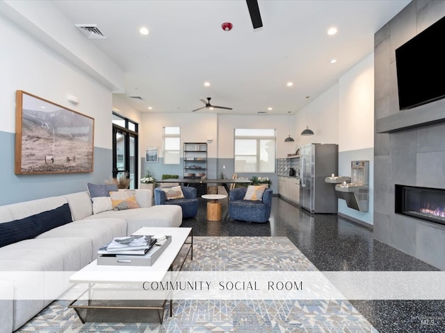 living room with recessed lighting, ceiling fan, visible vents, and a tile fireplace