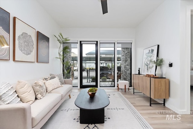 living room featuring ceiling fan and light wood-style flooring