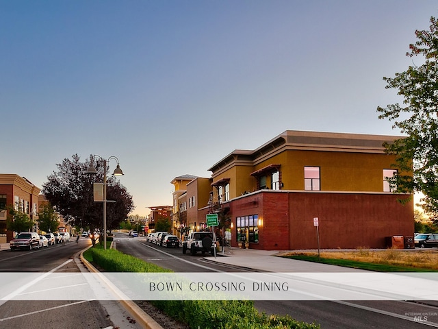 exterior space with street lighting, traffic signs, sidewalks, and curbs