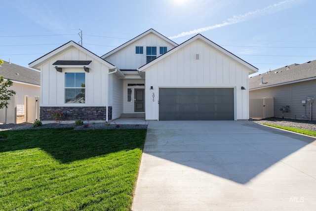 modern inspired farmhouse featuring a front lawn and a garage