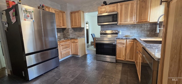 1118 10th St, Lewiston, ID 83501 - kitchen featuring stainless steel appliances, tasteful backsplash, and light stone countertops