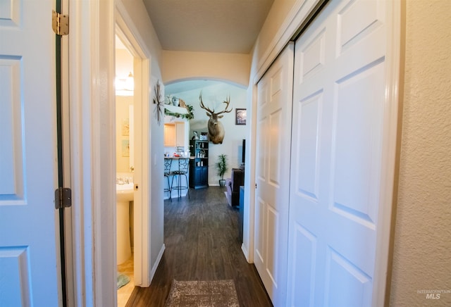 8340 E Expedition, Nampa, ID 83687 - hallway featuring dark wood-type flooring, arched walkways, and baseboards