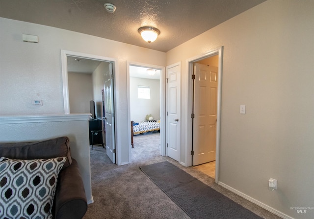 8340 E Expedition, Nampa, ID 83687 - hall featuring light carpet, a textured ceiling, and baseboards