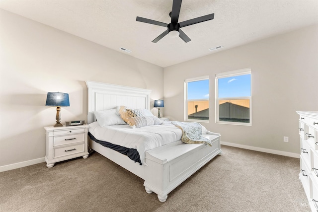 bedroom with carpet, ceiling fan, and a textured ceiling