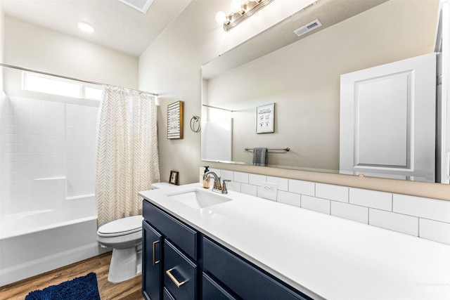 full bathroom with hardwood / wood-style floors, vanity, toilet, and shower / bath combination with curtain