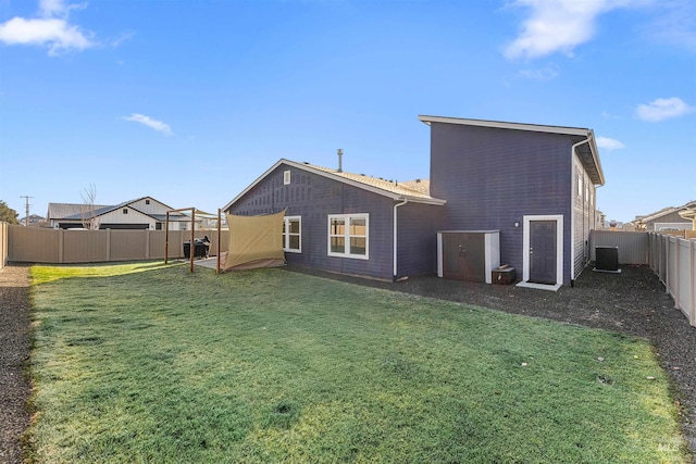 back of property featuring a yard and central AC unit