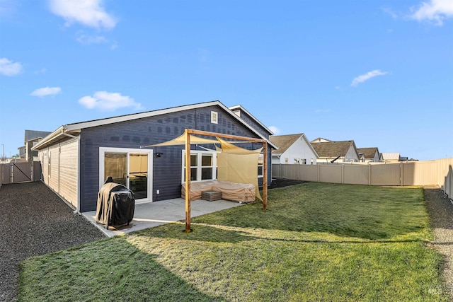 rear view of property featuring a yard and a patio