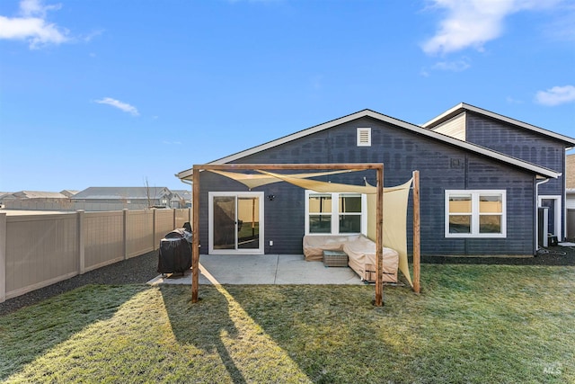 back of house featuring a yard and a patio