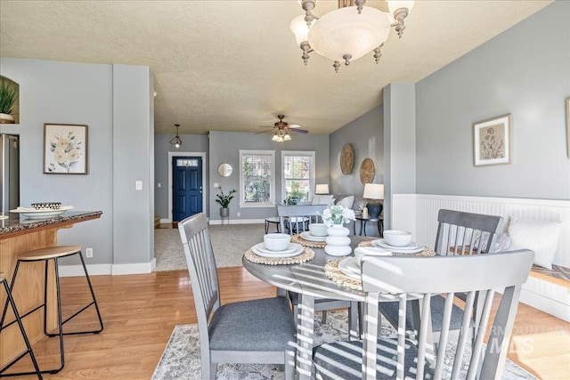 568 S Wooddale Pl, Eagle, ID 83616 - dining area with light wood-type flooring, a ceiling fan, baseboards, and a textured ceiling