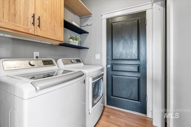568 S Wooddale Pl, Eagle, ID 83616 - laundry area with cabinet space, light wood finished floors, and washer and clothes dryer