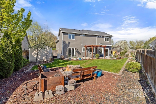 568 S Wooddale Pl, Eagle, ID 83616 - rear view of property featuring a fenced backyard, an outdoor structure, a lawn, an outdoor fire pit, and a storage unit