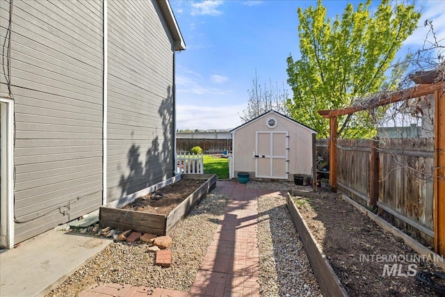 568 S Wooddale Pl, Eagle, ID 83616 - view of yard with a fenced backyard, a garden, an outbuilding, and a shed