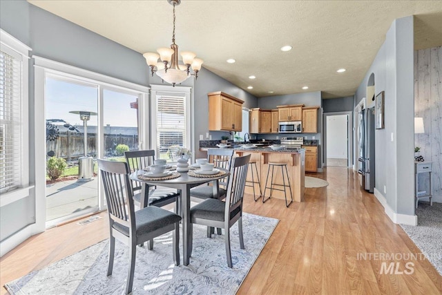 568 S Wooddale Pl, Eagle, ID 83616 - dining space with a notable chandelier, a textured ceiling, visible vents, and light wood-type flooring