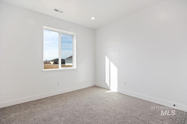 empty room with recessed lighting, visible vents, baseboards, and light colored carpet