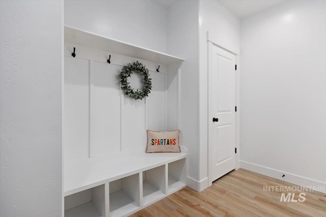 mudroom with wood finished floors and baseboards