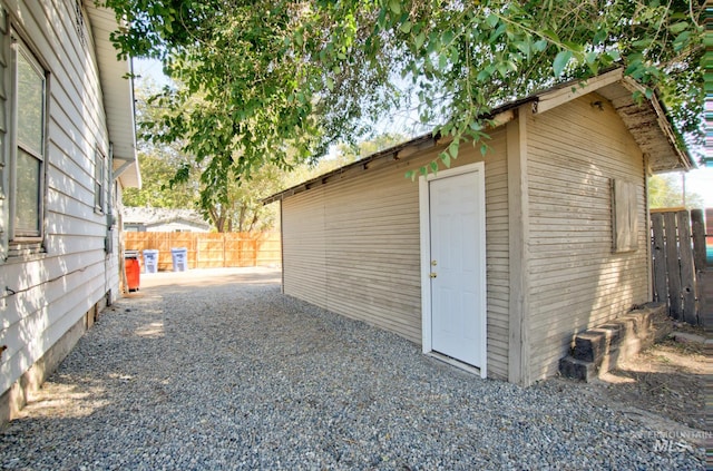 view of outbuilding featuring an outbuilding and fence