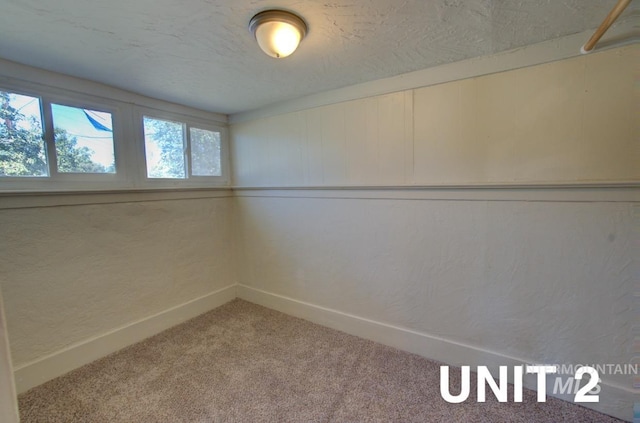 carpeted spare room with baseboards