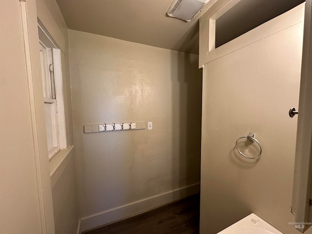 bathroom featuring visible vents, baseboards, and wood finished floors