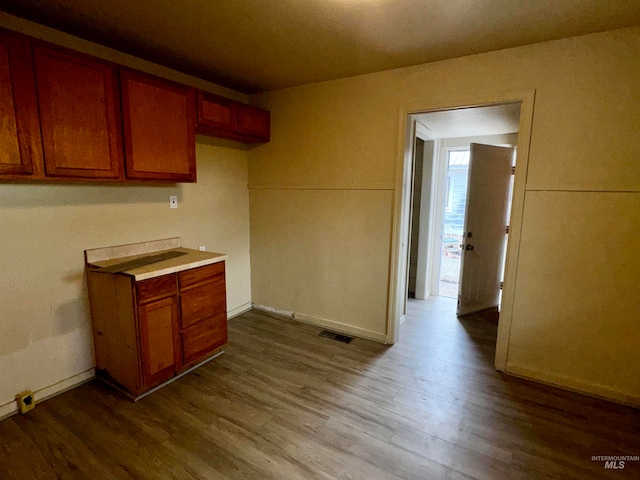 kitchen with visible vents, dark wood-type flooring, and light countertops