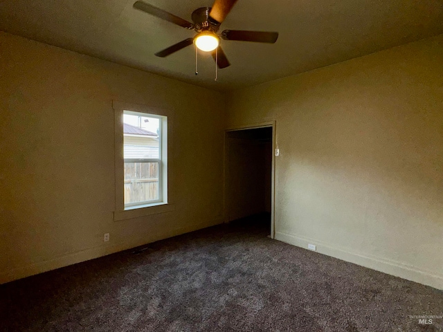 spare room featuring baseboards, ceiling fan, and carpet flooring