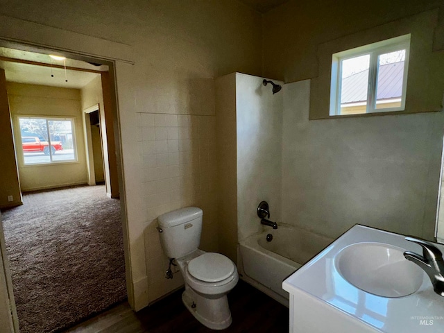 full bath featuring tub / shower combination, toilet, and vanity