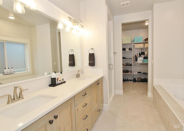 520 S Prospector Ln, Eagle, ID 83616 - bathroom featuring a walk in closet, a shower stall, tiled bath, double vanity, and backsplash