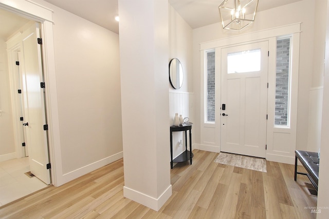 520 S Prospector Ln, Eagle, ID 83616 - entryway featuring light wood-style flooring, a chandelier, and baseboards