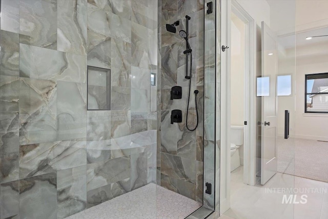 bathroom with a shower with shower door, toilet, and tile patterned flooring