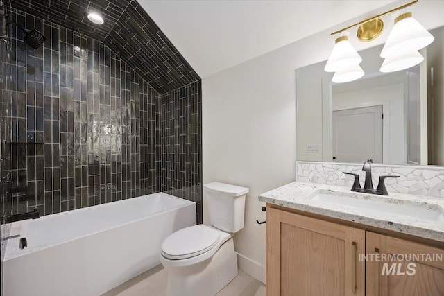 full bathroom with toilet, tiled shower / bath combo, and vanity