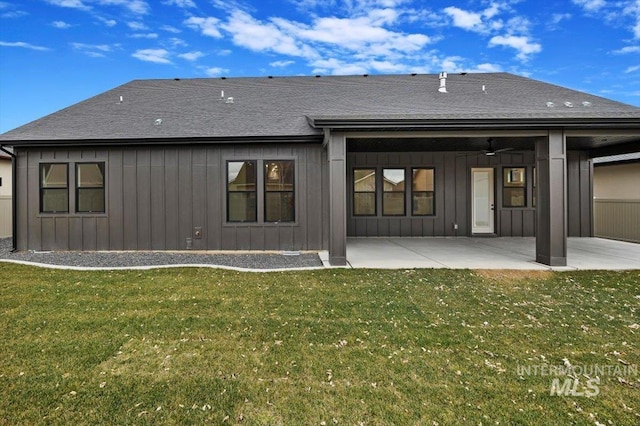 back of property with a patio area, a yard, and ceiling fan