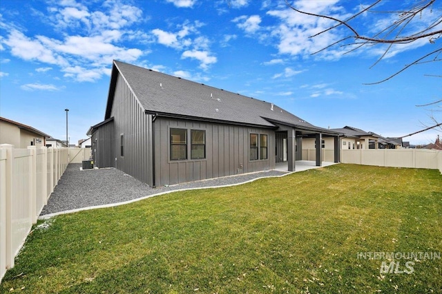 back of property featuring a patio area and a yard