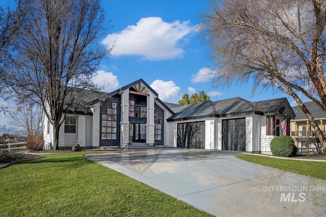 english style home with a garage and a front yard