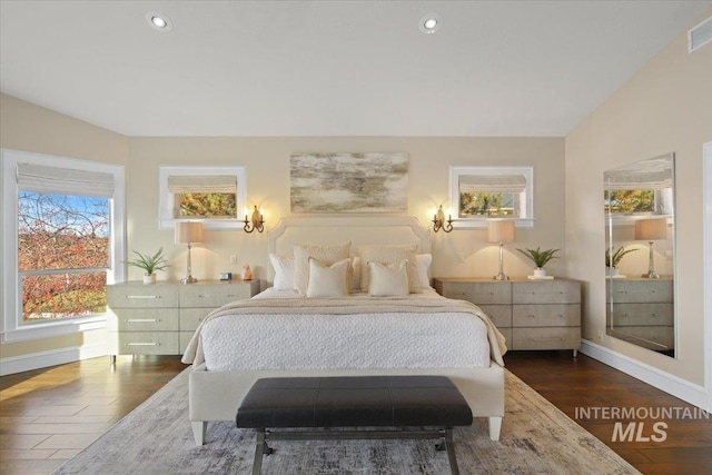 bedroom featuring dark wood-type flooring and vaulted ceiling