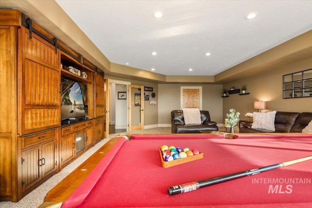 playroom with carpet flooring, billiards, and a textured ceiling