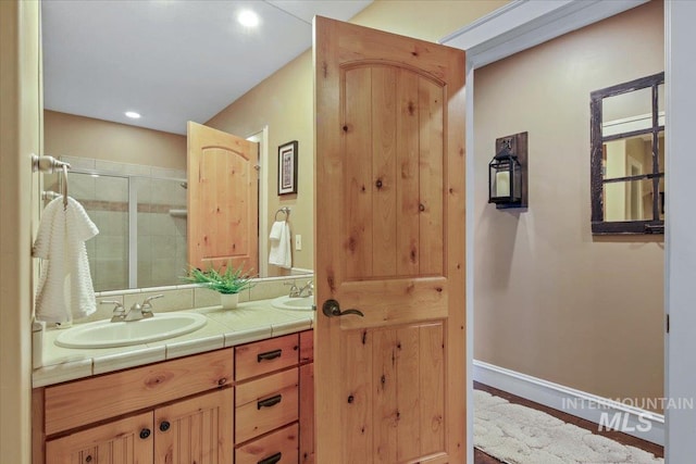 bathroom featuring vanity and an enclosed shower