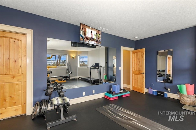 exercise room featuring a textured ceiling