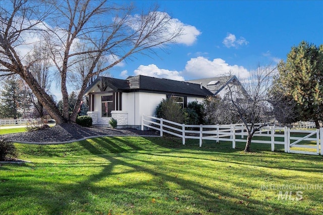 view of side of home featuring a yard