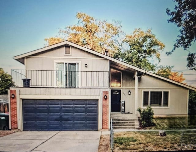 2315 NW 14th St, Meridian, ID 83646 - view of front facade featuring driveway, an attached garage, brick siding, and a balcony