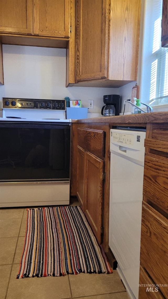 kitchen featuring tile patterned flooring and white appliances