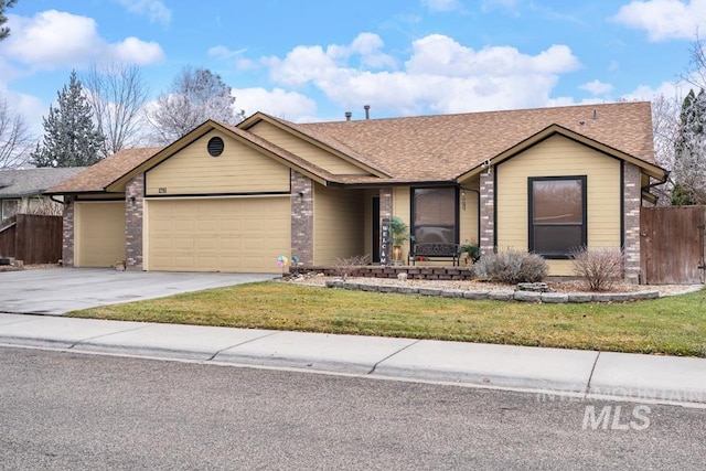 single story home with a front yard and a garage