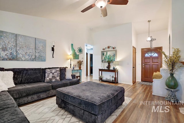 living room featuring light hardwood / wood-style floors and ceiling fan