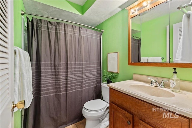 bathroom featuring tile patterned floors, a shower with shower curtain, toilet, and vanity