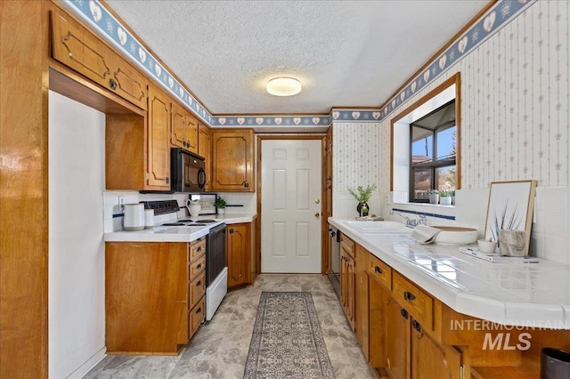 kitchen with wallpapered walls, brown cabinetry, black microwave, and range with electric cooktop