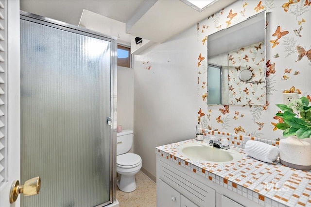 bathroom featuring a shower stall, wallpapered walls, toilet, vanity, and speckled floor